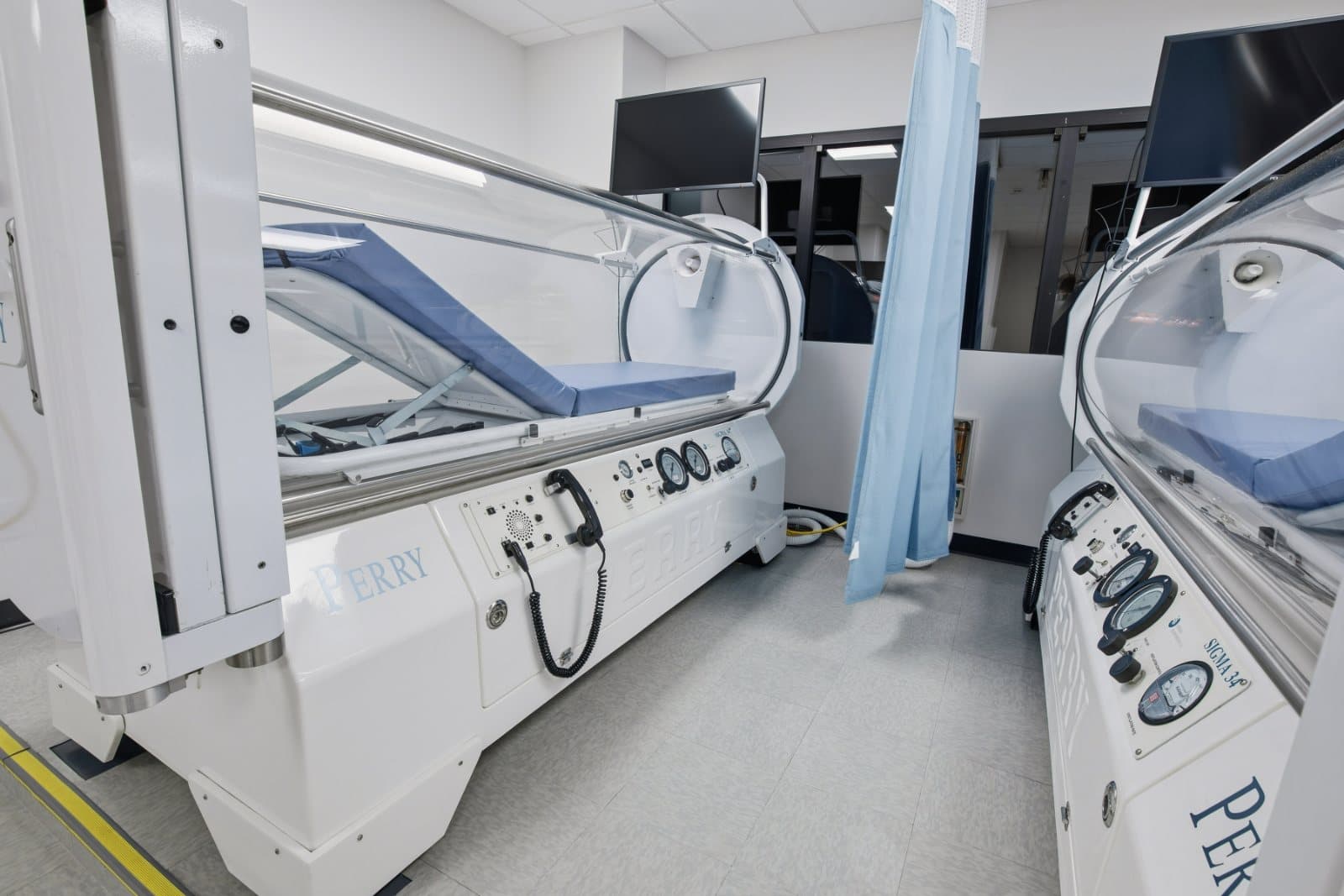 A clinical treatment room with hyperbaric chambers